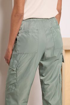 Dressed up or down, these Pistola pants will instantly upgrade your wardrobe. These chic cargo pants feature lightweight nylon fabric, an elastic tie waist with snap closure, and adjustable toggle hems to wear as a jogger or straight leg. Take them from day to night by swapping slides for strappy heels. | PISTOLA Women's Jade Lightweight Cargo Trouser Pants, Size Large, Green Nylon Bottoms With Pockets For Travel, Travel Bottoms With Elastic Waistband And Nylon Material, Nylon Cargo Pants With Functional Drawstring, Utility Nylon Pants With Functional Drawstring, Nylon Bottoms For Travel In Spring, Spring Travel Nylon Bottoms, Nylon Cargo Pants For Travel, Utility Nylon Parachute Pants With Drawstring, Utility Bottoms With Pockets For Travel