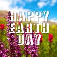 the words happy earth day are displayed in front of some wildflowers and blue sky