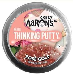 crazy aaron's thinking putty rose gold glitter in a tin with pink flowers