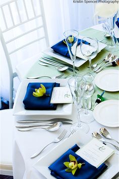 the table is set with place settings and napkins