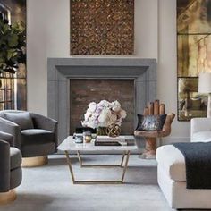 a living room filled with furniture and a fire place in front of a painting on the wall