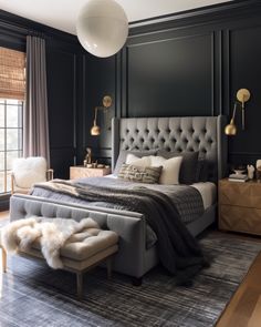 a bedroom with black walls and gray bedding, white fur rugs on the floor