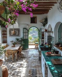 an open kitchen and dining area with potted plants