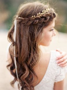 a woman with long hair wearing a white dress and gold leaves in it's hair