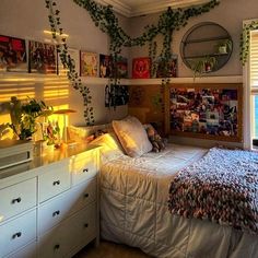 a bed room with a neatly made bed and lots of plants on the wall above it