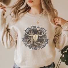 Raisin Hell with the Hippies and the Cowboys Sweatshirt - Trendznmore Bohemian Relaxed Fit Sweatshirt For Fall, Bohemian Crew Neck Sweatshirt With Relaxed Fit, Bohemian Crew Neck Relaxed Fit Sweatshirt, Bohemian Relaxed Fit Crew Neck Sweatshirt, Bohemian Graphic Print Tops For Rodeo, Western Sweatshirt Designs, Bohemian Graphic Print Rodeo Top, Wrangler Cow Print Sweatshirt, Western Graphic Sweatshirt