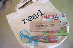 a bag with scissors, book worms and a sign reading read stafford goes to school