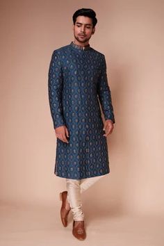 Teal raw silk sherwani with thread, sequin work structured jaal, water lily motifs and mandarin collar. Paired with cotton silk blend kurta and gathered churidar.
Component: 3
Pattern: Embroidered
Type Of Work: Thread and Sequin Work
Neckline: Mandarin Collar
Sleeve Type: Full Sleeves
Fabric: Sherwani: Raw Silk, Kurta and Churidar: Cotton Blend Silk
Color: Blue,Green
Other Details: 
Patch pocket
Front concealed closure
Front and side slits
Occasion: Groom,Destination Wedding - Aza Fashions Blue Sherwani, Embroidered Sherwani, Sherwani Groom, Wedding Sherwani, Nehru Jackets, Sherwani, Water Lily, Full Sleeves, Embroidered Silk