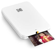 an open laptop computer with a polaroid print on the front and back cover, sitting next to it's printer