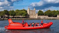 a red boat filled with people in the water