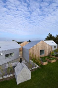 an aerial view of some houses in the grass