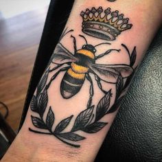 a bee with a crown tattoo on its arm