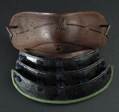 three different types of leather belts stacked on top of each other with holes in them