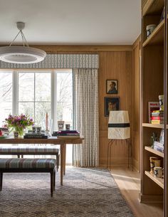 a dining room table and bench in front of a window