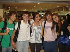 four young people are posing for the camera