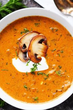 a white bowl filled with soup and mushrooms