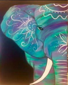 an elephant painted in blue and green with white swirls on it's trunk