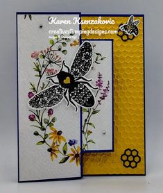 a close up of a card with flowers and a bee on the front, and an insect on the back