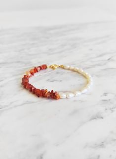 Sea Jewels. This unique piece is inspired by tropical sea creatures. This bracelet is composed of raw orange carnelian gemstones and ivory baroque freshwater pearls. Such a modern yet free spirited piece! Available in: ❉ 14K Yellow Gold vermeil ❉ 14K Rose Gold vermeil ❉ 925 Sterling Silver Not sure which length to buy? We can add a 1 inch extender chain. Just write a note at checkout! ❈ We send all our items with registered mail. ❉ Due to the organic nature of stones, there might be a slight variation in colour, size and shape. ✺ All items come packaged in a quality velvet pouch ready for gift giving. ✽ If you want to make a special order, just contact us! Handmade Adjustable Baroque Pearl Beaded Bracelets, Elegant Orange Beaded Bracelets With Gemstones, Elegant Orange Beaded Bracelet With Natural Stones, Elegant Orange Gemstone Beaded Bracelets, Handmade Baroque Pearl Beaded Bracelets Gift, White Pearl Bracelets With Gemstones, Orange Carnelian Bracelets With Natural Stones, White Pearl Gemstone Bracelets, Handmade White Bracelets With Baroque Pearls