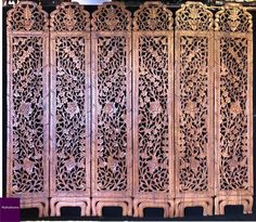 an intricately carved wooden screen is shown