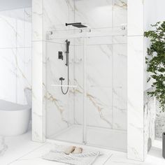 a bathroom with white marble walls and flooring, including a walk - in shower