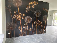 a large painting of dandelions on a wall in a room with tile flooring