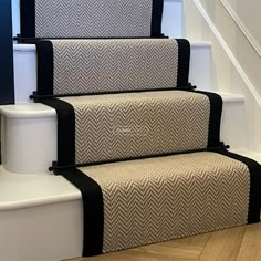 a set of stairs with black and white carpet