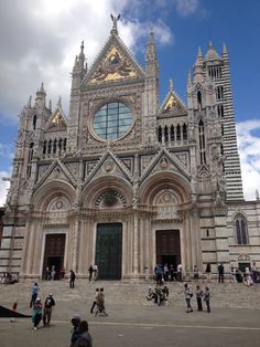 people are standing in front of an old church