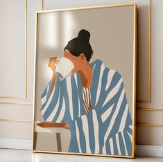 a man drinking from a paper cup in front of a framed poster on the wall