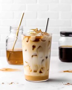 an iced coffee drink with gold flakes on the rim and topped with whipped cream