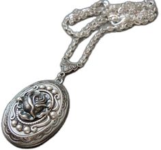 Silver Round Pendant With Rose Design, Silver Necklace With Rose Design And Round Pendant, Victorian Silver Jewelry For Valentine's Day, Silver Oval Jewelry With Flower Charm, Adjustable Silver Locket Necklace As Gift, Adjustable Silver Locket Necklace For Gifts, Vintage Silver Necklaces With Rose Design, Silver Flower Pendant Jewelry With Rose Design, Silver Locket Necklace With Flower Pendant For Anniversary