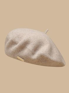 a white hat on top of a tan background