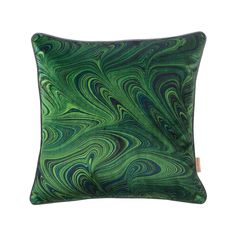 a green and blue pillow with swirls on the front, sitting on a white surface