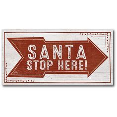 a red and white sign that says santa stop here with an arrow pointing to the right