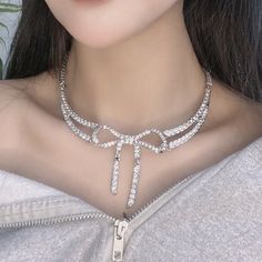 Make any outfit glam with this shiny rhinestone bow choker necklace. Elegant Bow Choker Jewelry, Bow Choker Jewelry For Parties, Party Cubic Zirconia Choker, Elegant Bow Choker Necklace, Formal Rhinestone Clavicle Choker Necklace, Formal Rhinestone Choker Necklace, Party Choker With Bow Detail, Bow Choker, Rhinestone Bow