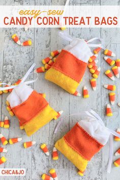 candy corn treat bags on a wooden table with candy candies around them and text overlay that says easy - sew candy corn treat bags