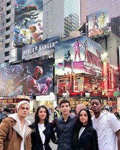 some people are posing for a picture in times square