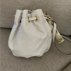 You Are Looking At A Brand New (With Tags) Authentic Coach Peyton Bucket Bag!! This Bag Is A Pretty Cream Color With Gold Hardware. It Has Patent Leather Strap That Is Even More Cream Colored That Cinches At The End To Close The Bag. This Bag Has A Top Handle And A Removable Crossbody/Shoulder Strap. The Clip That Makes The Shoulder Strap Removable Has “Coach” Written On Them And It Comes With A Patent Leather Coach Label Keychain Charm. The Inside Of This Bag Has A White With Gold Polka Dot Lin Keychain Charm, Gold Polka Dots, Leather Coach, Leather Bucket, Coach Handbags, Coach Bags, Cream Color, Gold Hardware, Top Handle