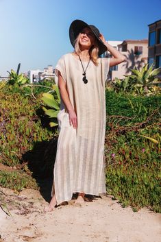 Whether you will wear it as an over-bikini cover-up, or as a dress on its own, you will be able to achieve an elevated look with our Collette Kaftan. Delicate and sophisticated, this linen kaftan will be a perfect fit at a resort by the sea, or at any poolside setting. You can also wear it as a tunic over a slip dress, shorts and even jeans. Collette Kaftan is one size. Due to its breathable transparency, you can purchase it together with our Leah cotton slip dress, that is available in sizes S, Beige V-neck Linen Dress For Beach, Beachwear Maxi Dress With Side Slits For Beach Cover-up, Chic Long Kaftan For Beach, Beachwear Kaftan For The Beach, Unlined Beach Kaftan, Beachwear Unlined Kaftan For Beach, Unlined Beach Kaftan For Beachwear, Chic Long Kaftan For Beach Season, V-neck Linen Dress For The Beach