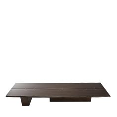 a wooden table sitting on top of a white wall