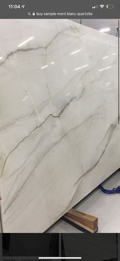 a large white marble slab is being worked on