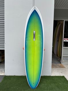 a surfboard is propped up against the wall