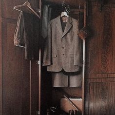 an open closet with clothes and shoes on it