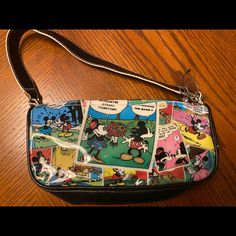 Mickey And Minnie Mouse Comic Strip Handbag/Purse. Authentic Disney Reflects Various Mickey And Minnie Comic Strips Silver Mickey Mouse Zipper Pull Light Blue Lining With Additional Zipper Compartment Black Sides, Bottom And Straps Item Details Color: Multi-Color Bag: Approximately 9” X 5” Strap: Approximately 18” End To End Strap Drop (Top Of Strap To Bottom Of Bag): Approximately 12” Never Used Multi Colored Bag, Disney Handbags, Mickey And Minnie Mouse, Disney Bag, Drop Top, Mickey And Minnie, Handbag Purse, Comic Strip, Blue And Silver