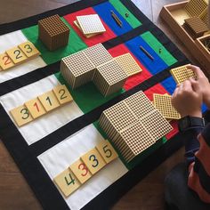 a child is playing with wooden blocks and numbers