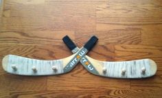 two white skis with black straps sitting on top of a wooden floor