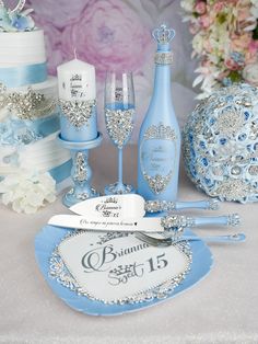 a table topped with lots of blue and silver items