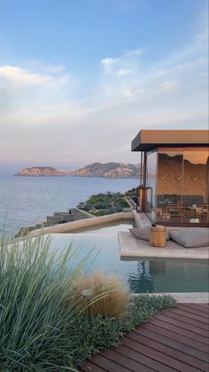 an outdoor hot tub next to the ocean