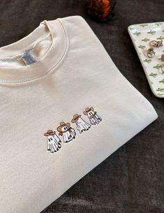 three white t - shirts sitting on top of a table