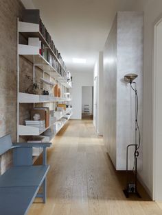 an empty room with shelves and blue benches